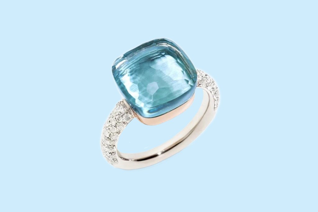 A blue gemstone in a women's ring